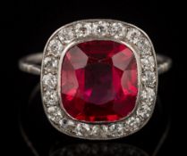 A synthetic ruby and diamond cushion shaped cluster ring: the synthetic ruby approximately 11.