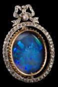 A homogenous black and white opal and diamond brooch: the oval opal stated to be approximately 21.