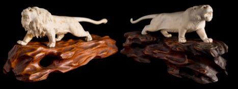 Two Japanese carved ivory okimonos, one signed Gyokudan: of a tiger and a lion,