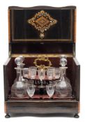 A 19th century ebonised and brass inlaid liqueur casket: of rectangular serpentine outline,