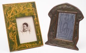An Art Nouveau period bronzed metal photograph frame: of arched outline with embossed decoration of