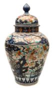A Japanese Imari oviform jar and domed cover: decorated with chrysanthemum,
