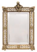 A Victorian brass easel frame mirror: the bevelled rectangular mirror plate enclosed by a pierced