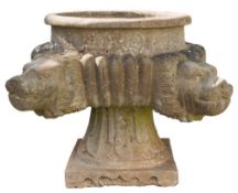A reconstructed stone circular garden urn:, with projecting lions masks to the corners,