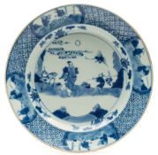 A Chinese porcelain dish: painted in blue with two figures in a landscape containing a deer and a