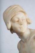 An alabaster figure of a Dutch girl: wearing a tied bodice and long skirt and sabots with a