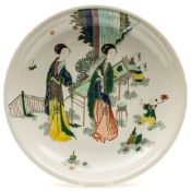 A pair of Chinese porcelain dishes: enamelled in the famille verte palette with a pair of elegant