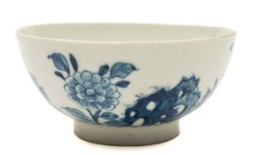 A Lowestoft blue and white waste bowl: painted with pierced rockwork, peony and other floral sprays,