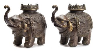 A pair of Japanese patinated bronze elephant incense burners: each caparisoned elephant with