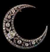 A 19th century diamond mounted crescent brooch: with graduated old brilliant-cut and rose-cut