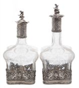 Two near matching Continental silver mounted etched glass decanters and stoppers,