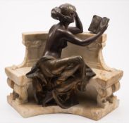 A late 19th century spelter and marble figure group: of a neoclassical semi-naked maiden seated