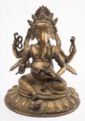 A bronze figure of Ganesha: in traditional costume, seated on a lotus flower, 29cm. high.