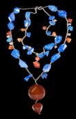 A lapis lazuli and cornelian agate bead necklace: with attached animal motif pendants and