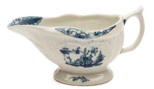 A Lowestoft blue and white creamboat: of ribbed relief moulded form,
