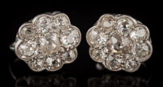 A pair of diamond oval cluster earrings: pave-set with cushion shaped, old-cut diamonds,