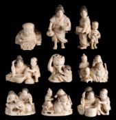 A collection of nine Japanese carved and stained ivory okimonos: figural subjects, including Budai,