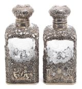 A pair of Continental silver mounted etched glass scent bottles: with domed hinged lids,