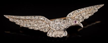 A rose diamond mounted eagle in flight brooch: pave-set throughout with rose diamonds and single