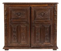 A part 17th Century and later Italian carved oak side cupboard:,
