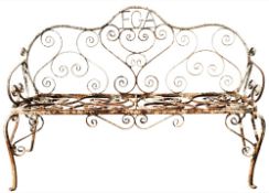 A wrought iron garden seat:, with scrollwork designs on cabriole legs, the back with initials F. G.