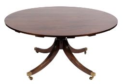 A mahogany circular 'segmented' extending dining table in the Regency taste by Martin Dodge:,