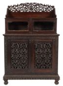 A 19th Century Anglo-Indian carved hardwood side cabinet,: in two parts,