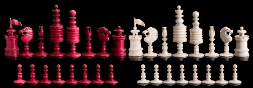 An Indian bone Barleycorn pattern chess set: one side stained red, the other left natural,