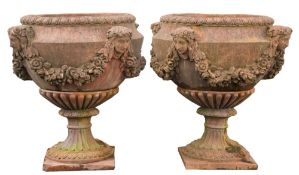 A pair of terracotta circular garden pedestal urns:,