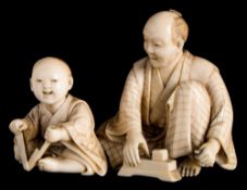 A Japanese carved ivory okimono of father and son knife sharpeners: both seated,