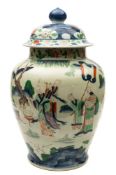 A Chinese porcelain oviform jar and domed cover: enamelled in famille verte enamels and under glaze