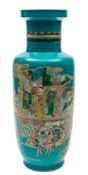 A Chinese famille verte turquoise ground rouleau vase: painted with dignitaries on a verandah with
