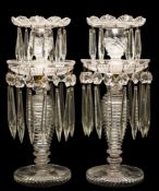 A pair of 19th century cut glass table lustres: of circular two-tiered form hung with pendants and