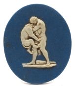 An unusual Enoch Wood blue and white jasperware oval relief plaque: depicting Heracles wrestling