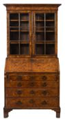 An 18th Century walnut bureau bookcase:, the upper part with a moulded cornice,
