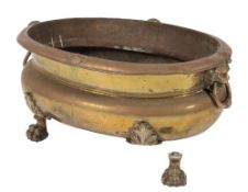 An early 19th Century brass oval jardiniere or wine cooler:, the rim with shell ornament,