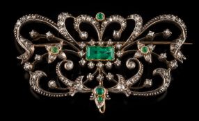 An emerald and rose diamond mounted plaque brooch: of scroll work design,