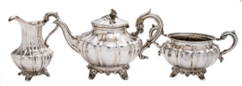 A matched silver three-piece tea service, various maker's and dates: of fluted melon-shaped outline,