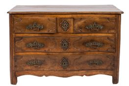 An 18th Century French Provincial walnut serpentine fronted commode:, the top with a moulded edge,