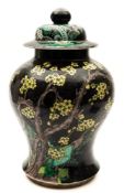 A Chinese verte noire porcelain vase and cover: of baluster form with domed cover,