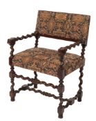 A carved walnut open armchair:, in the 17th Century taste, with machine tapestry seat and back,