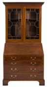 A George III mahogany bureau bookcase:, the upper part with a moulded dentil cornice,
