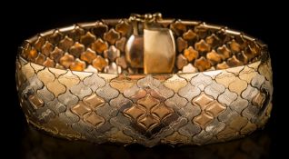 A three-colour bracelet of wide textured linking: the clasp stamped '750', approximately 19cm long,