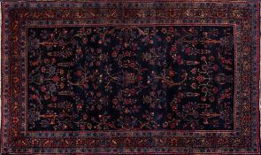 A Meshed rug:, the indigo field with palmette and floral foliate sprays,