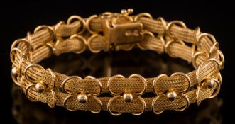 A two-strand mesh-link bracelet: with applied loop and bead decoration, 25.6gms gross weight.