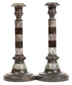 A pair of serpentine and marble candlesticks:,