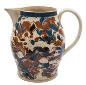 A large late 18th century marbled creamware jug: of baluster form, slip decorated with bold blue,