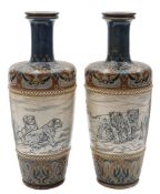 A pair of rare Doulton Lambeth stoneware vases decorated with lions by Hannah Barlow: each with