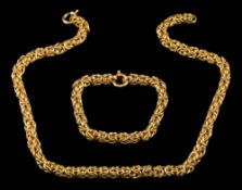 A necklace of byzantine linking: stamped '18Kt', 47cm long and a matching bracelet,
