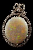 A homogenous black and white opal and diamond brooch: the oval opal stated to be approximately 21.